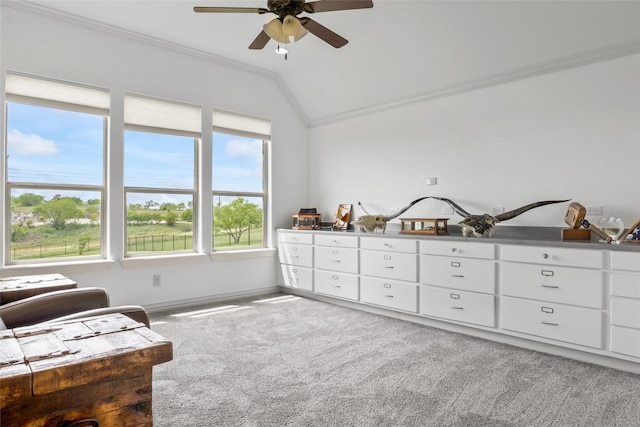 living area with carpet flooring, crown molding, baseboards, ceiling fan, and vaulted ceiling