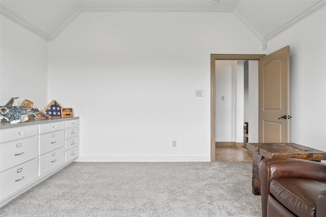 interior space with baseboards, ornamental molding, carpet floors, and vaulted ceiling