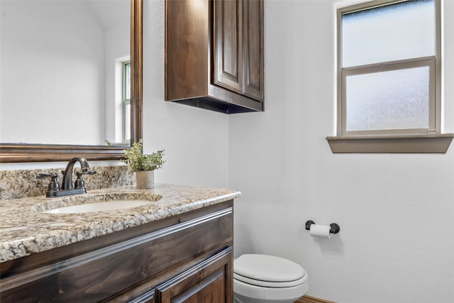 bathroom featuring toilet and vanity
