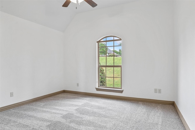 carpeted empty room with lofted ceiling, baseboards, and ceiling fan