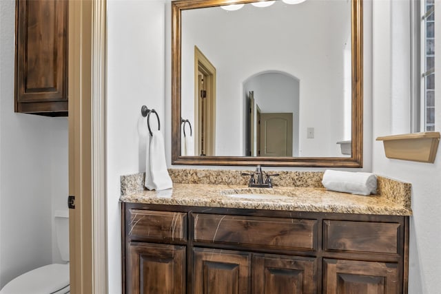 bathroom featuring toilet and vanity