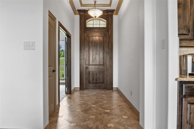 entryway featuring ornamental molding, baseboards, and a healthy amount of sunlight
