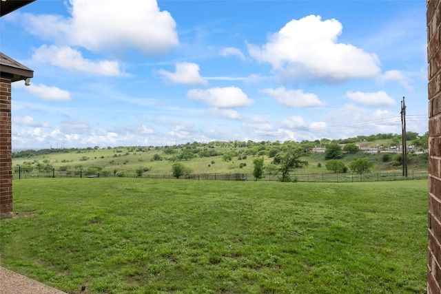 view of yard featuring a rural view and fence
