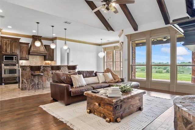 living area featuring lofted ceiling with beams, visible vents, recessed lighting, ceiling fan, and wood-type flooring