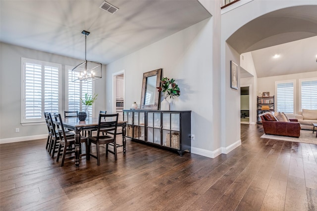4011 Hollywood Park Ct, Celina, TX 75009 - dining space with arched walkways, a chandelier, dark wood-style flooring, and baseboards