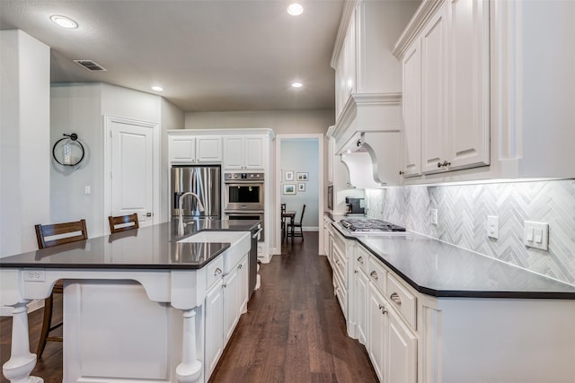 4011 Hollywood Park Ct, Celina, TX 75009 - kitchen with appliances with stainless steel finishes, dark countertops, white cabinetry, and recessed lighting