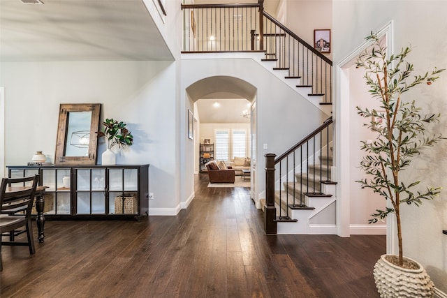 4011 Hollywood Park Ct, Celina, TX 75009 - entrance foyer featuring arched walkways, wood-type flooring, stairs, a high ceiling, and baseboards
