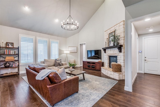 4011 Hollywood Park Ct, Celina, TX 75009 - living room with baseboards, dark wood-style flooring, a chandelier, a fireplace, and high vaulted ceiling