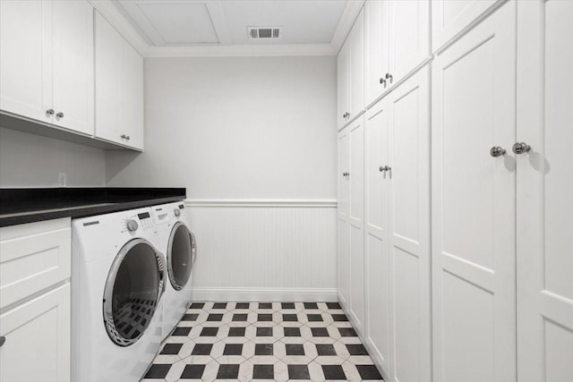 laundry area featuring cabinet space, washer and clothes dryer, a wainscoted wall, baseboards, and ornamental molding