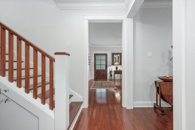 foyer entrance featuring stairs, dark wood-style flooring, ornamental molding, and baseboards