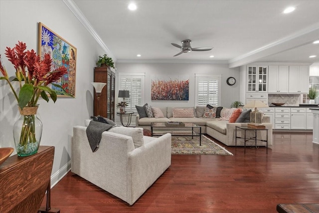 living room featuring ceiling fan, recessed lighting, ornamental molding, dark wood-style flooring, and baseboards