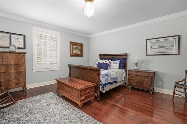 bedroom featuring wood finished floors, crown molding, and baseboards
