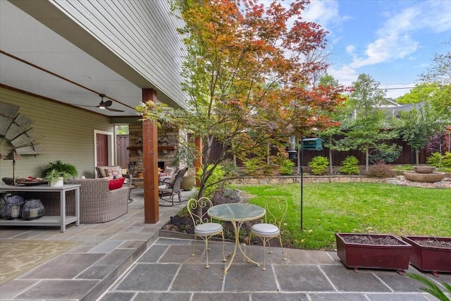 view of yard featuring a patio, a ceiling fan, and an outdoor living space