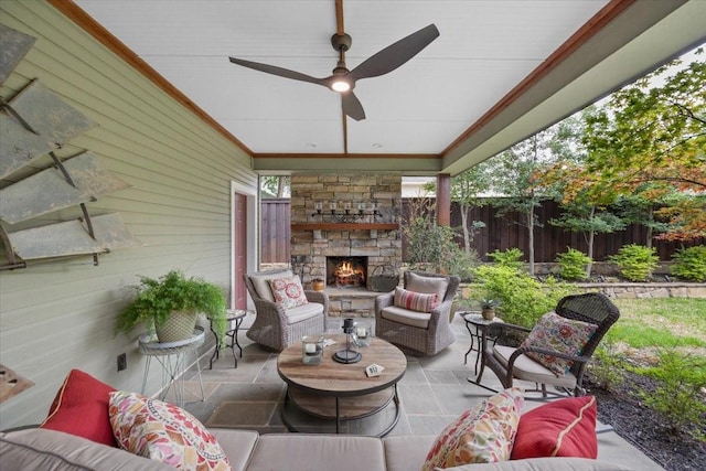 sunroom / solarium featuring ceiling fan and an outdoor living space with a fireplace