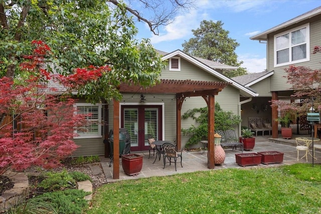 rear view of house featuring french doors, a pergola, a patio, and a lawn