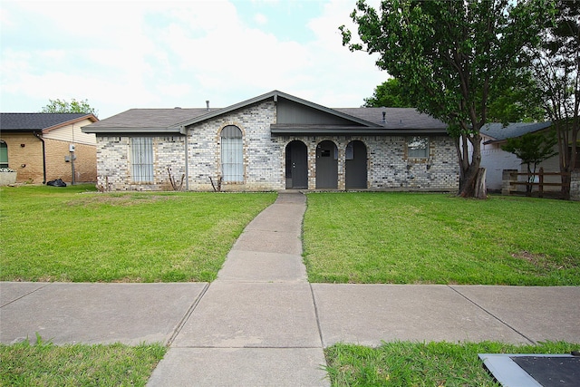 710 Longbeach Dr, Garland, TX 75043 - view of front of property featuring brick siding and a front lawn