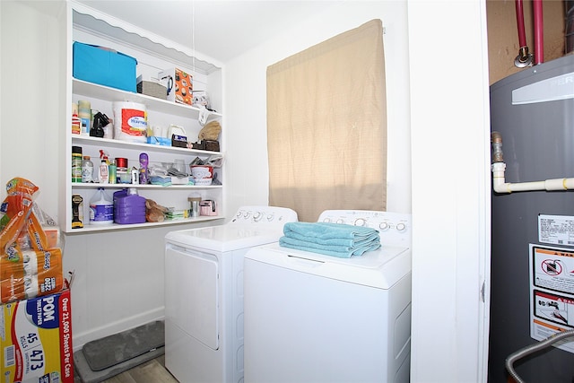 710 Longbeach Dr, Garland, TX 75043 - laundry room featuring water heater, wood finished floors, washing machine and clothes dryer, and laundry area