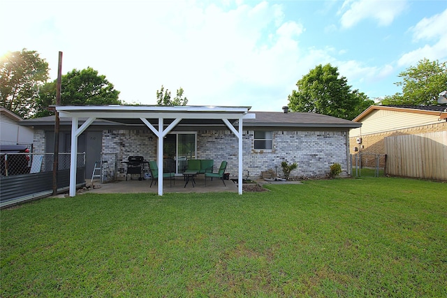710 Longbeach Dr, Garland, TX 75043 - back of property featuring brick siding, a yard, a patio, and a fenced backyard