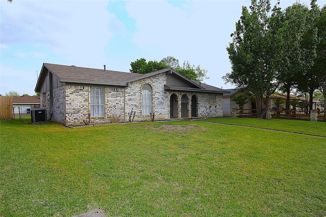 710 Longbeach Dr, Garland, TX 75043 - back of property featuring brick siding, a lawn, and central AC unit