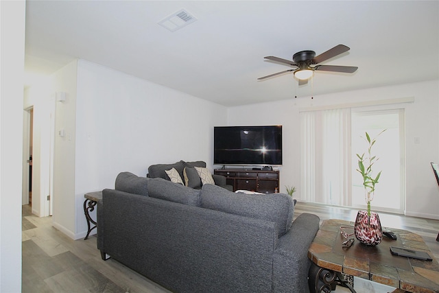710 Longbeach Dr, Garland, TX 75043 - living area with light wood-style flooring, visible vents, baseboards, and ceiling fan