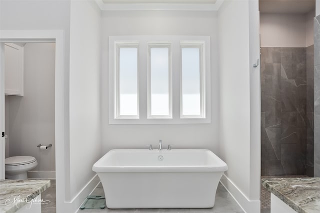 bathroom with tiled shower, baseboards, a freestanding bath, and toilet