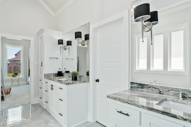 bathroom featuring crown molding, vanity, marble finish floor, baseboards, and lofted ceiling