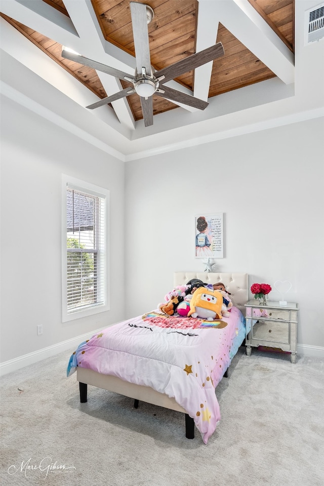 bedroom with baseboards, carpet, beam ceiling, and wooden ceiling