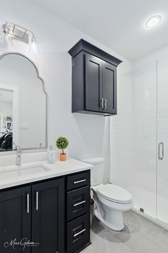 ensuite bathroom featuring vanity, connected bathroom, a shower stall, and toilet
