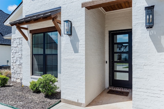 property entrance with brick siding