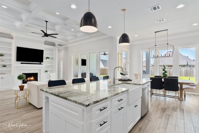 kitchen featuring visible vents, stainless steel dishwasher, and a healthy amount of sunlight