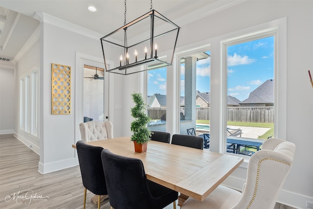 dining area featuring an inviting chandelier, light wood-style floors, visible vents, and baseboards