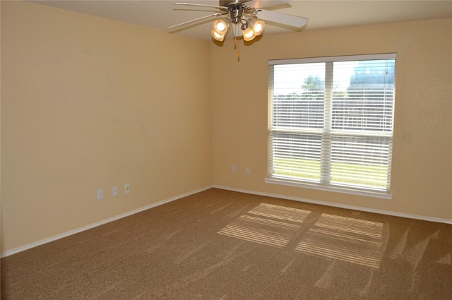 spare room featuring carpet flooring, baseboards, and ceiling fan