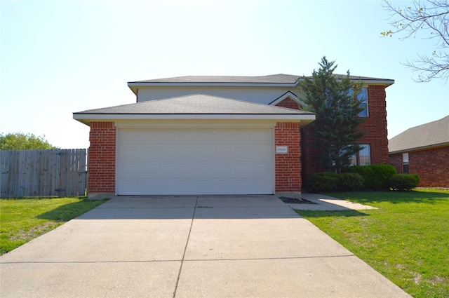 view of front of home featuring fence, driveway, a front lawn, and brick siding