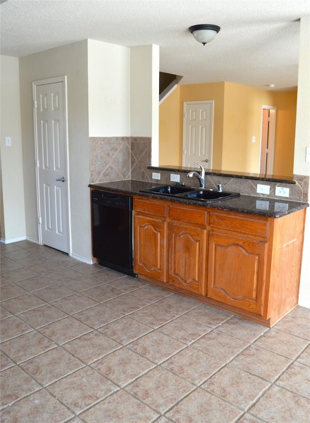 kitchen with a sink, dark stone countertops, decorative backsplash, brown cabinets, and dishwasher
