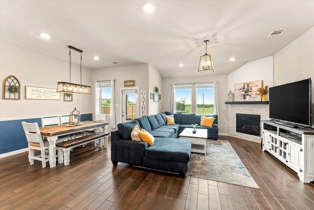 3912 Burks Ct, Celina, TX 75009 - living room featuring dark wood-style flooring, recessed lighting, a glass covered fireplace, baseboards, and a chandelier