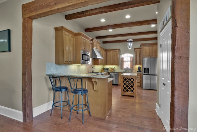 kitchen featuring stainless steel appliances, recessed lighting, backsplash, wood finished floors, and under cabinet range hood