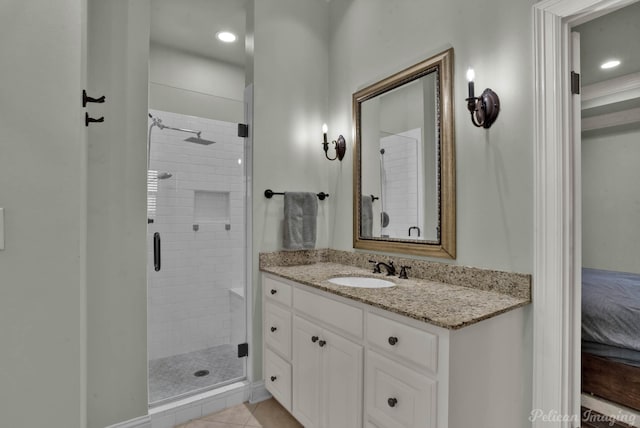 bathroom featuring tile patterned floors, vanity, and a stall shower