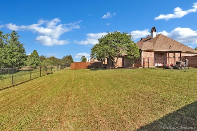 view of yard with a fenced backyard