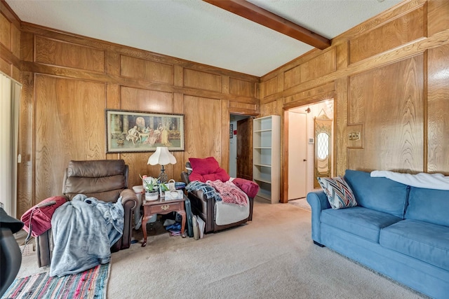 carpeted living area with beamed ceiling and wooden walls