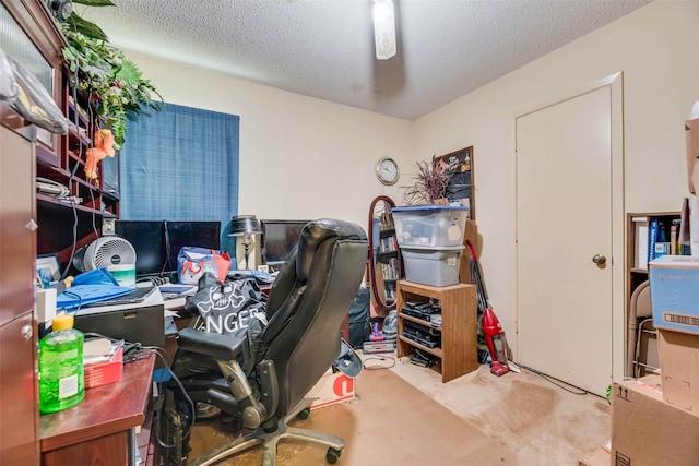 carpeted home office with a textured ceiling