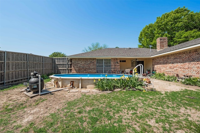 outdoor pool featuring a yard and fence
