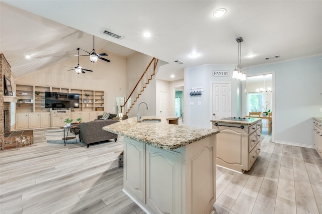300 Dove Crk, Mckinney, TX 75071 - kitchen featuring visible vents, a kitchen island with sink, a sink, light wood-style flooring, and ceiling fan with notable chandelier