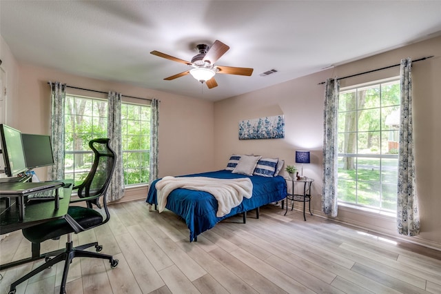 300 Dove Crk, Mckinney, TX 75071 - bedroom with ceiling fan, multiple windows, wood finished floors, and visible vents