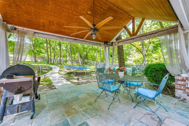 300 Dove Crk, Mckinney, TX 75071 - view of patio featuring a ceiling fan, a trampoline, a gazebo, a fenced backyard, and outdoor dining space