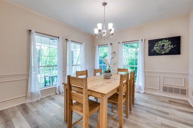 300 Dove Crk, Mckinney, TX 75071 - dining area with an inviting chandelier, ornamental molding, a decorative wall, and visible vents