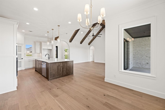 737 Burr Oak Ln, Weatherford, TX 76085 - kitchen featuring recessed lighting, an island with sink, a sink, arched walkways, and open floor plan