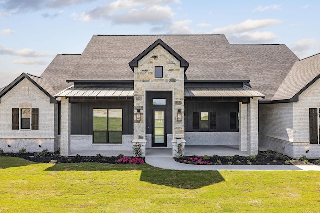 737 Burr Oak Ln, Weatherford, TX 76085 - french country style house with board and batten siding, a front lawn, and brick siding