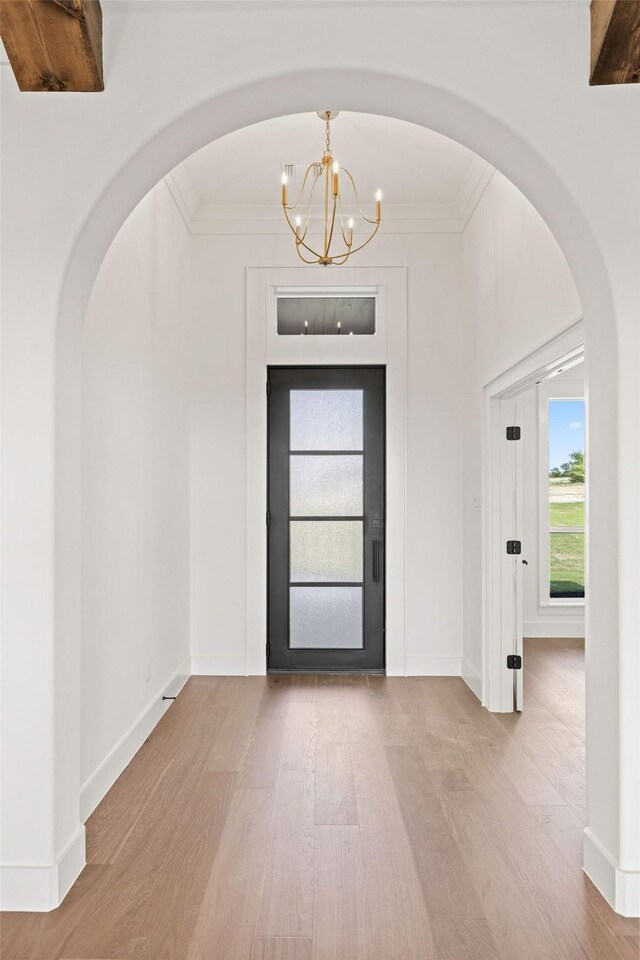 737 Burr Oak Ln, Weatherford, TX 76085 - entryway with arched walkways, baseboards, an inviting chandelier, wood finished floors, and ornamental molding