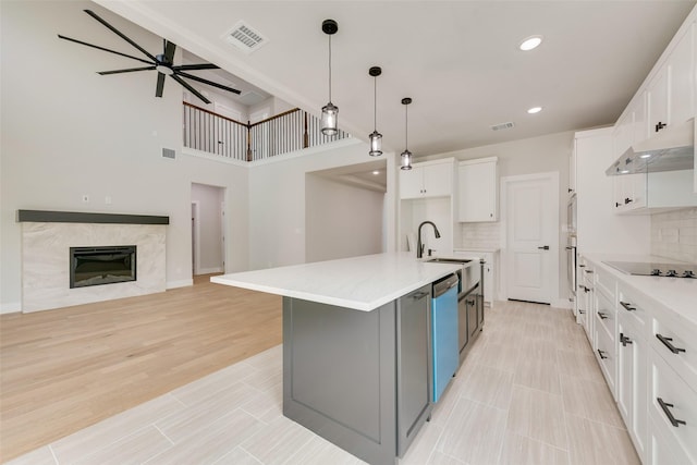 6810 Windward View Dr, Rowlett, TX 75088 - kitchen featuring dishwashing machine, under cabinet range hood, white cabinets, a ceiling fan, and light countertops
