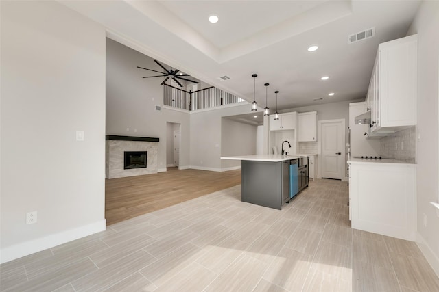 6810 Windward View Dr, Rowlett, TX 75088 - kitchen featuring white cabinetry, ceiling fan, baseboards, an island with sink, and recessed lighting